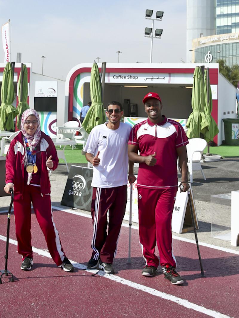 Three athletes pose for a photo