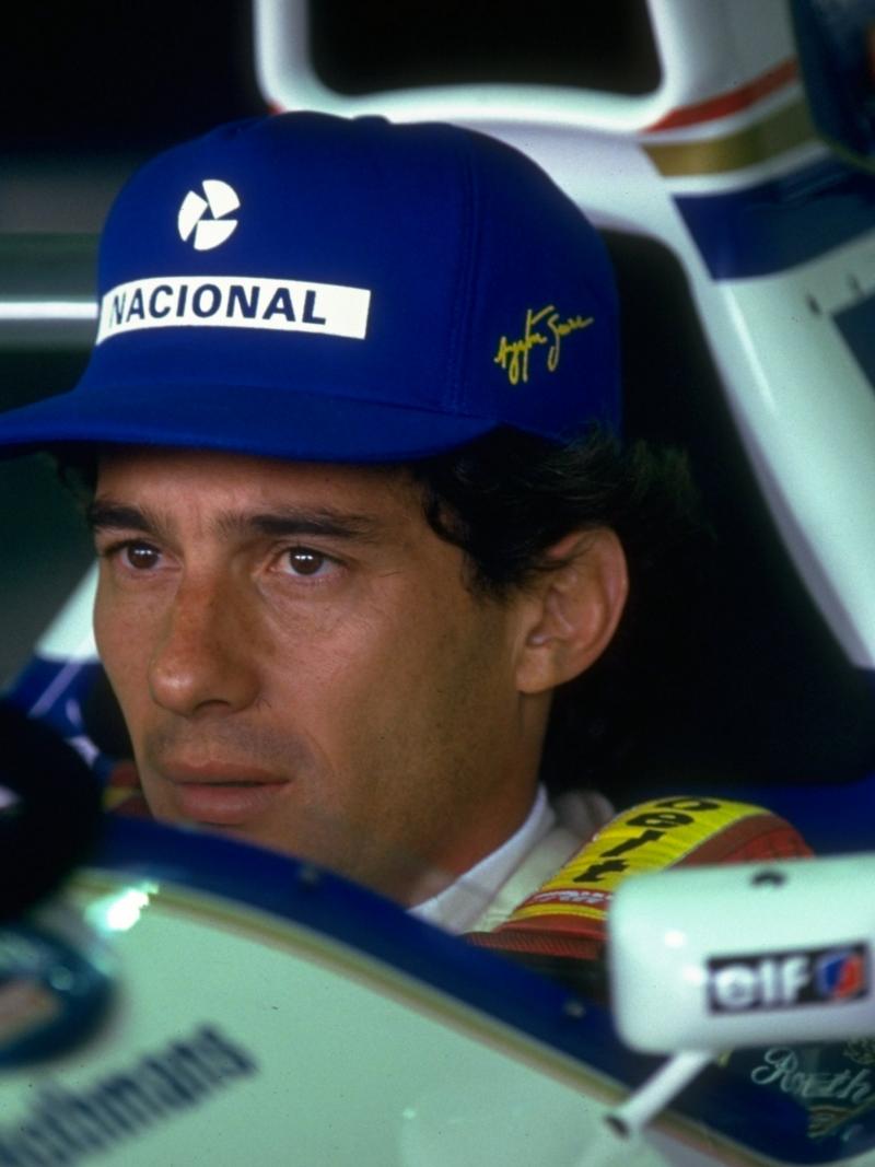 Face of a man sitting in a Formula 1 car.