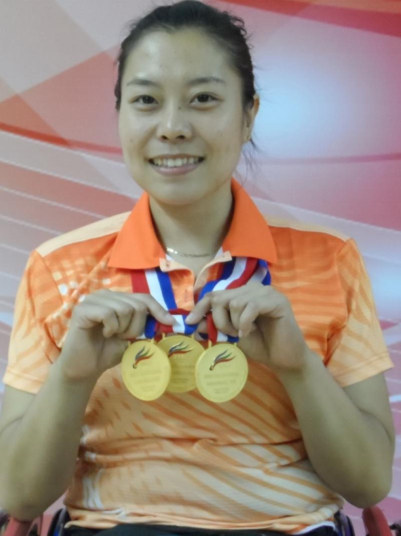 Woman holding medals