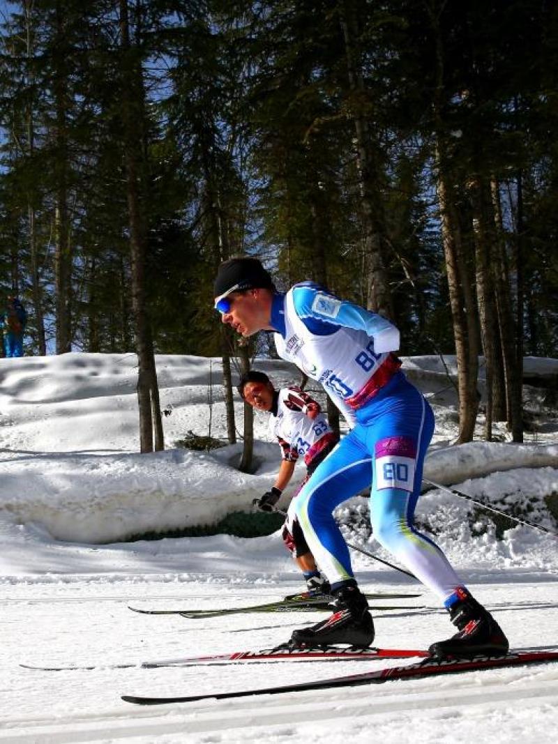 Ilkka Tuomisto of Finland and Dexin Zhou of China compete in the Men's Cross Country 10km Free Standing at the Sochi 2014 Paralympic Winter Games.