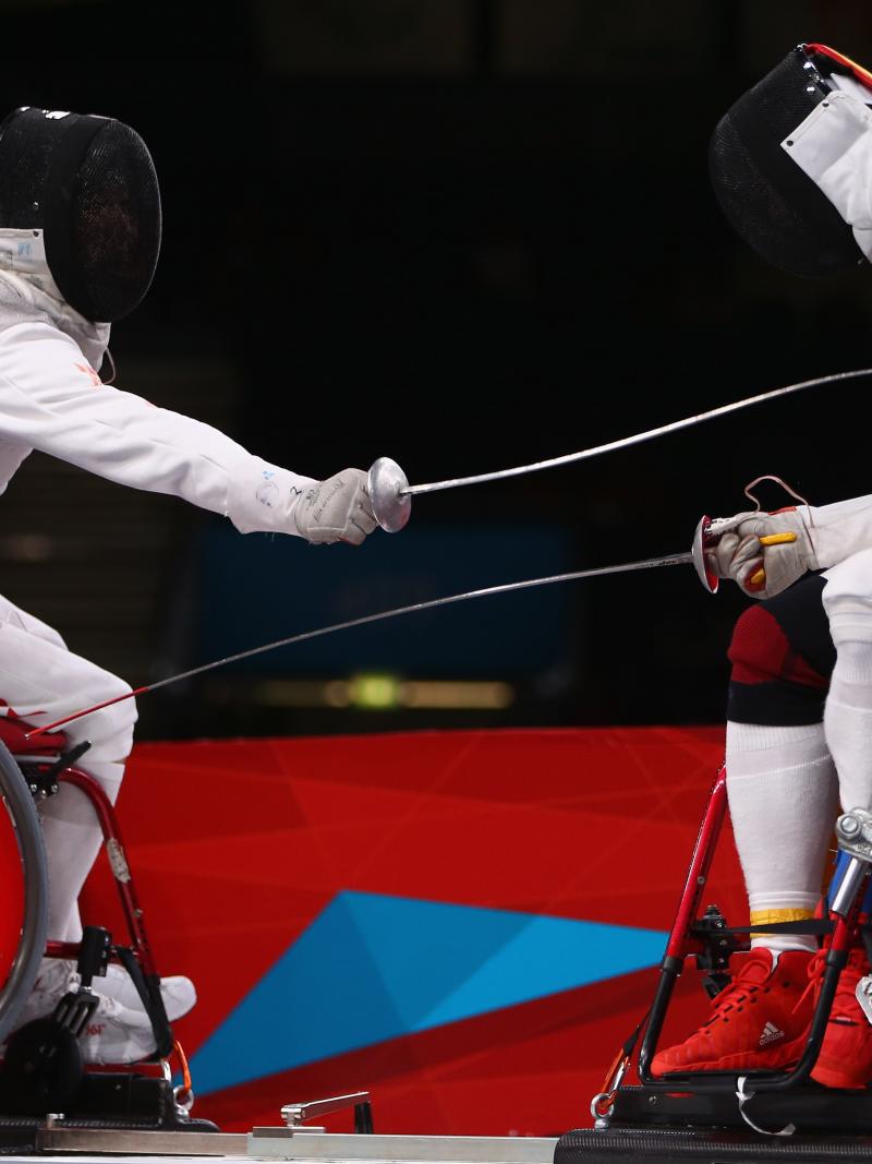 Ruyi Ye (L) of China on his way to winning gold against Yijun Chen (R) of China during the men's individual foil category A final of the wheelchair fencing at the London 2012 Paralympic Games.