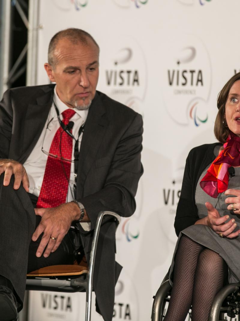 Two delgates speak at a conference