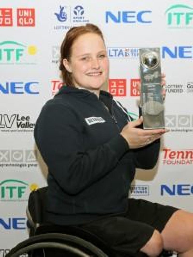 Woman with a cup, sitting in a wheelchair