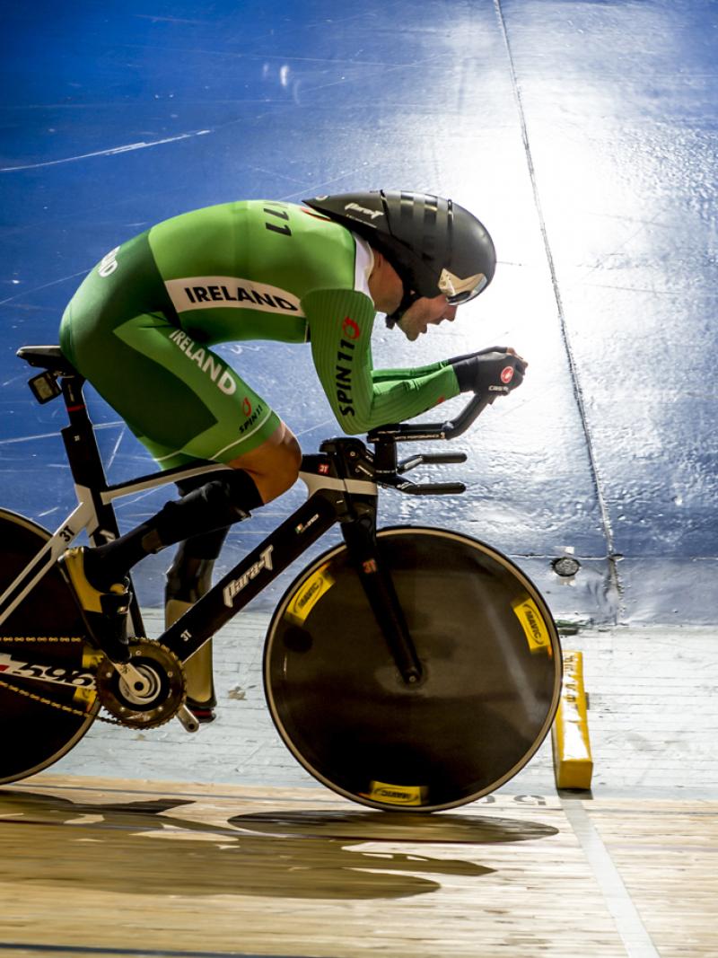 Man on a bike, cycling on a track