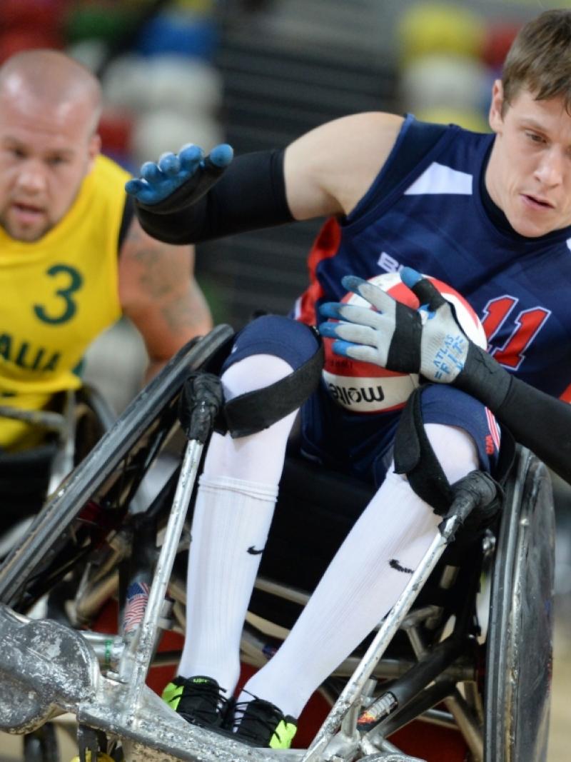 Two wheelchair rugby players fighting for the ball