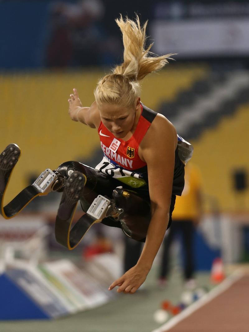 Double leg amputee woman doing long jump
