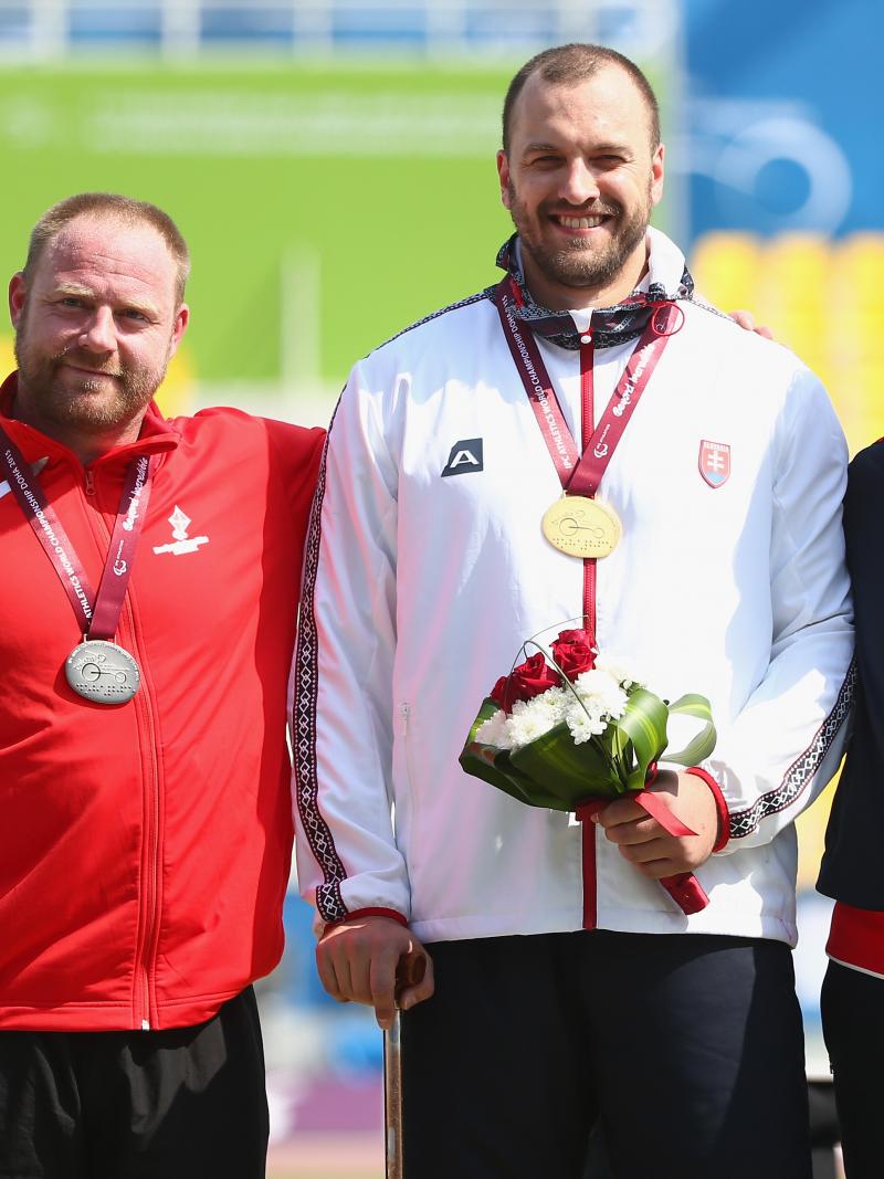 Podium with three men showing their medals