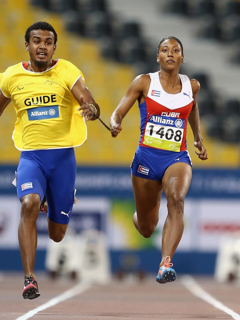 Woman and man sprinting on a track side by side