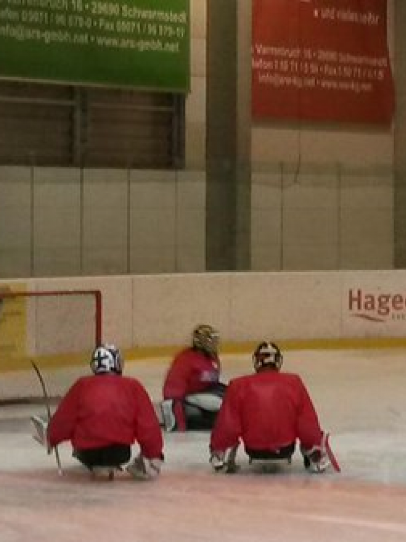 Young ice sledge hockey players take part in a training camp
