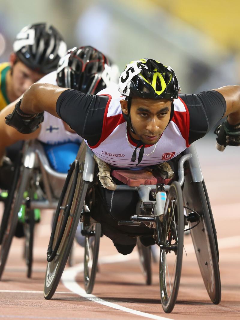 Man leading a pack in a wheelchair race