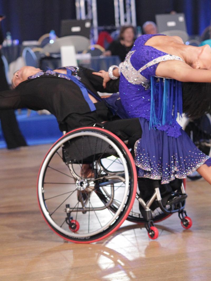 Man in wheelchair and woman performe.