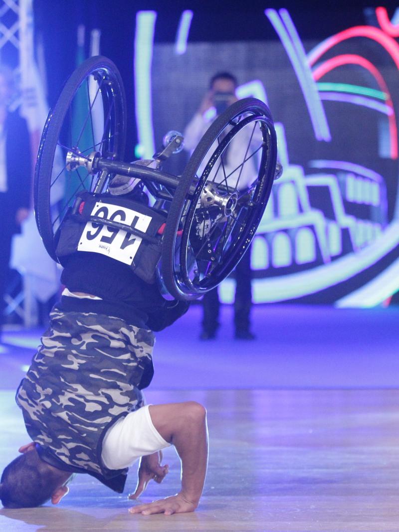 Man in wheelchair does headstand