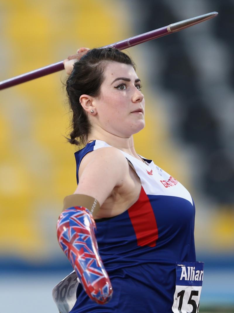 Woman with arm prosthesis throwing a javelin