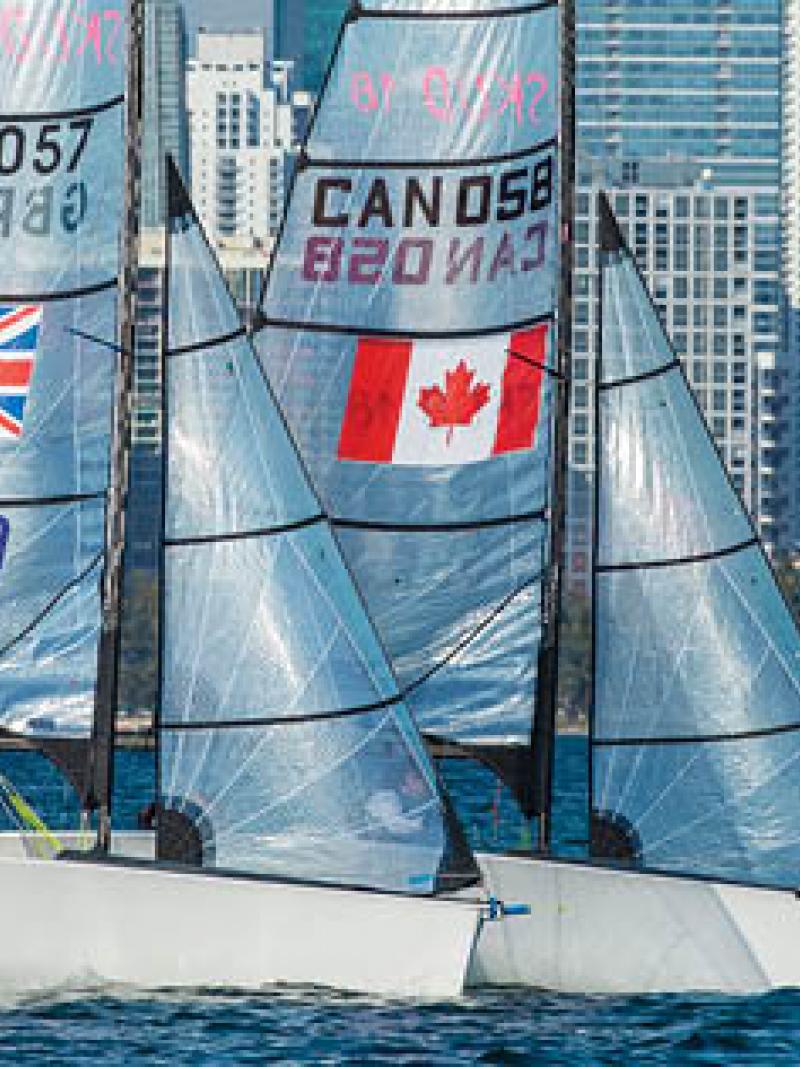 Two sailing boats in the water with skyline in the background