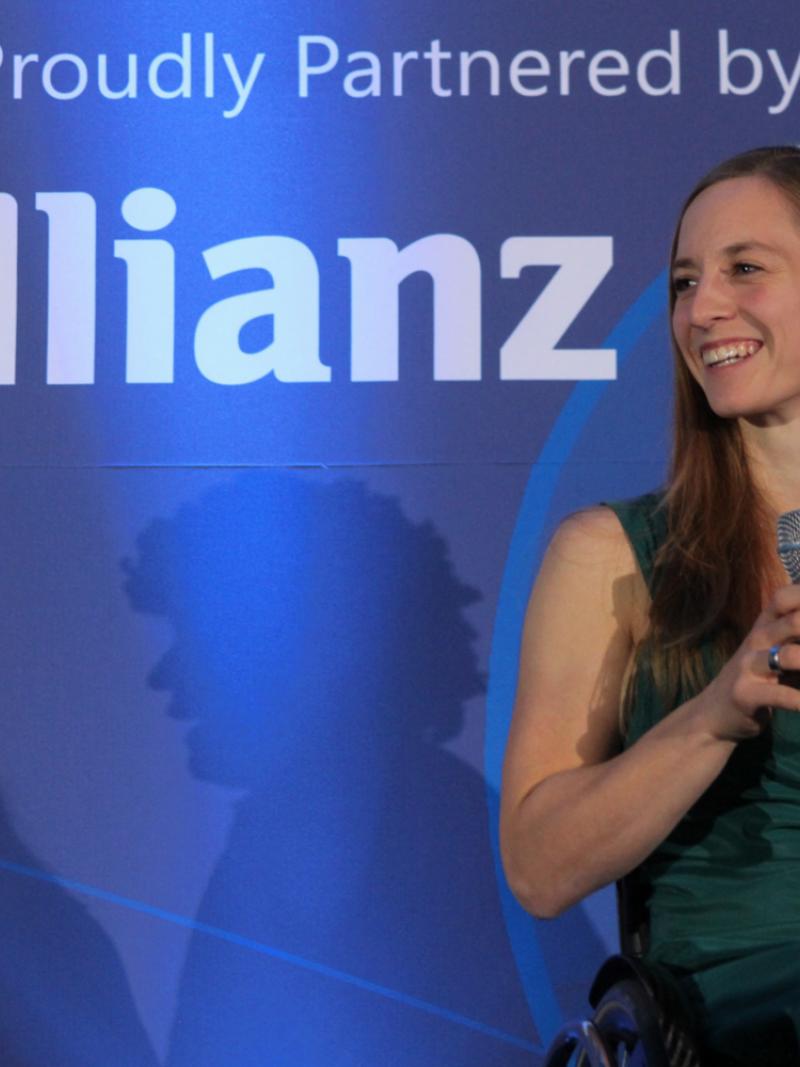 Anna Schaffelhuber with her awards trophy, smiling