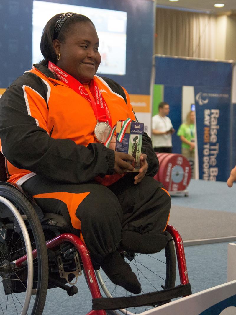 Woman in wheelchar with medal around her neck