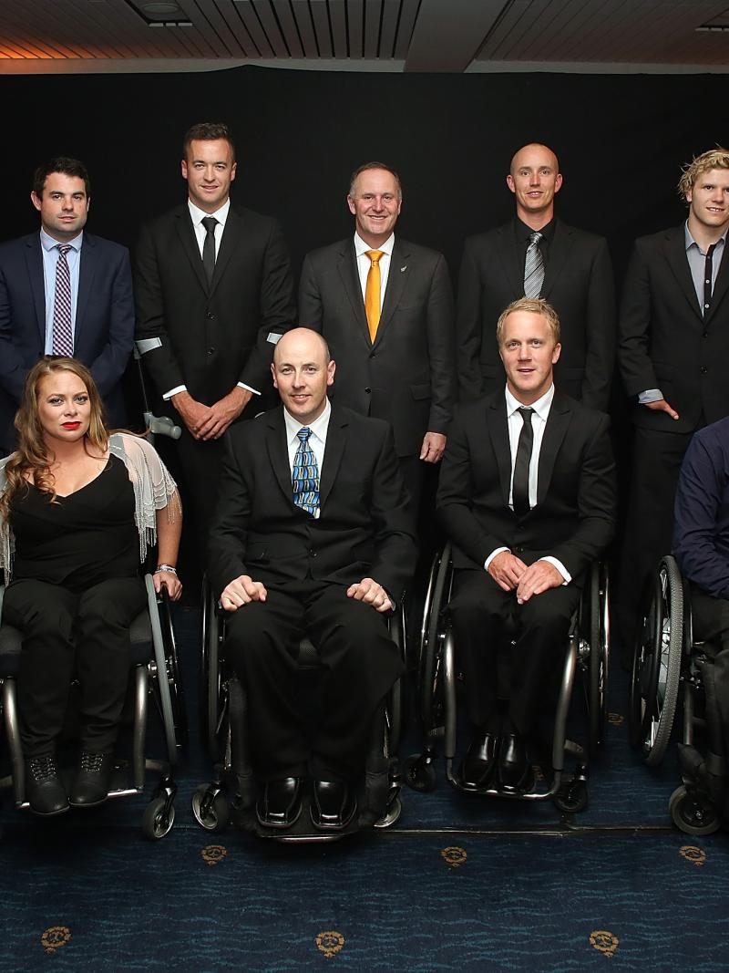 Group picture of people dressed smart, standing and in wheelchairs