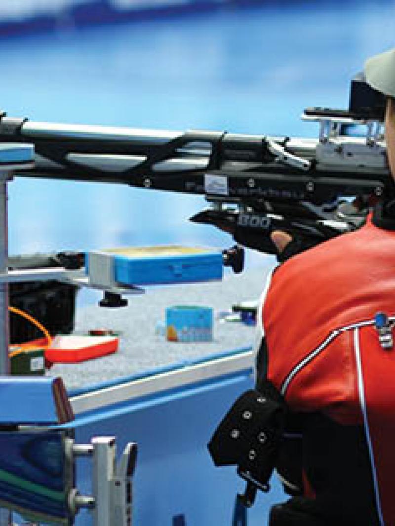 Women from the back, targeting with a rifle