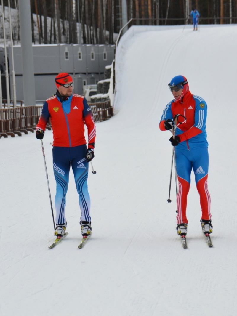 Two cross-country skier in blue competition clothes on the slopes