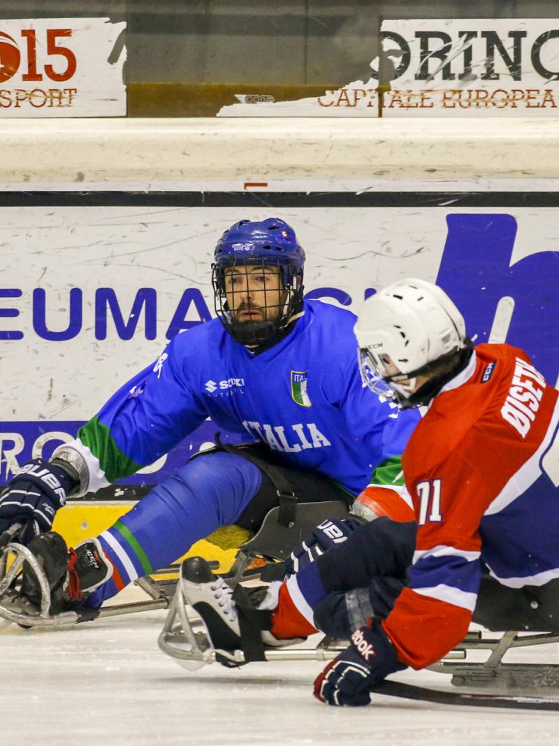 Two ice sledge hockey players in action