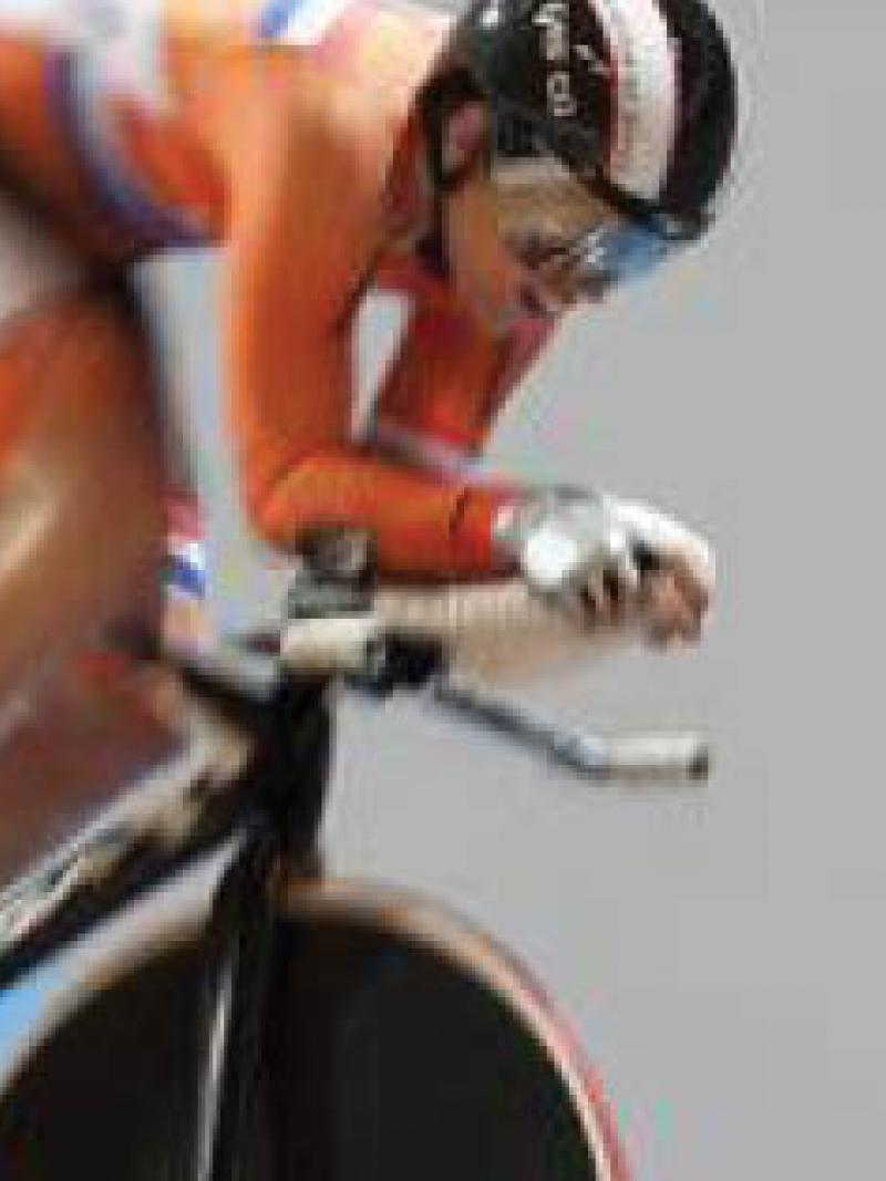 Cylist riding around a velodrome 