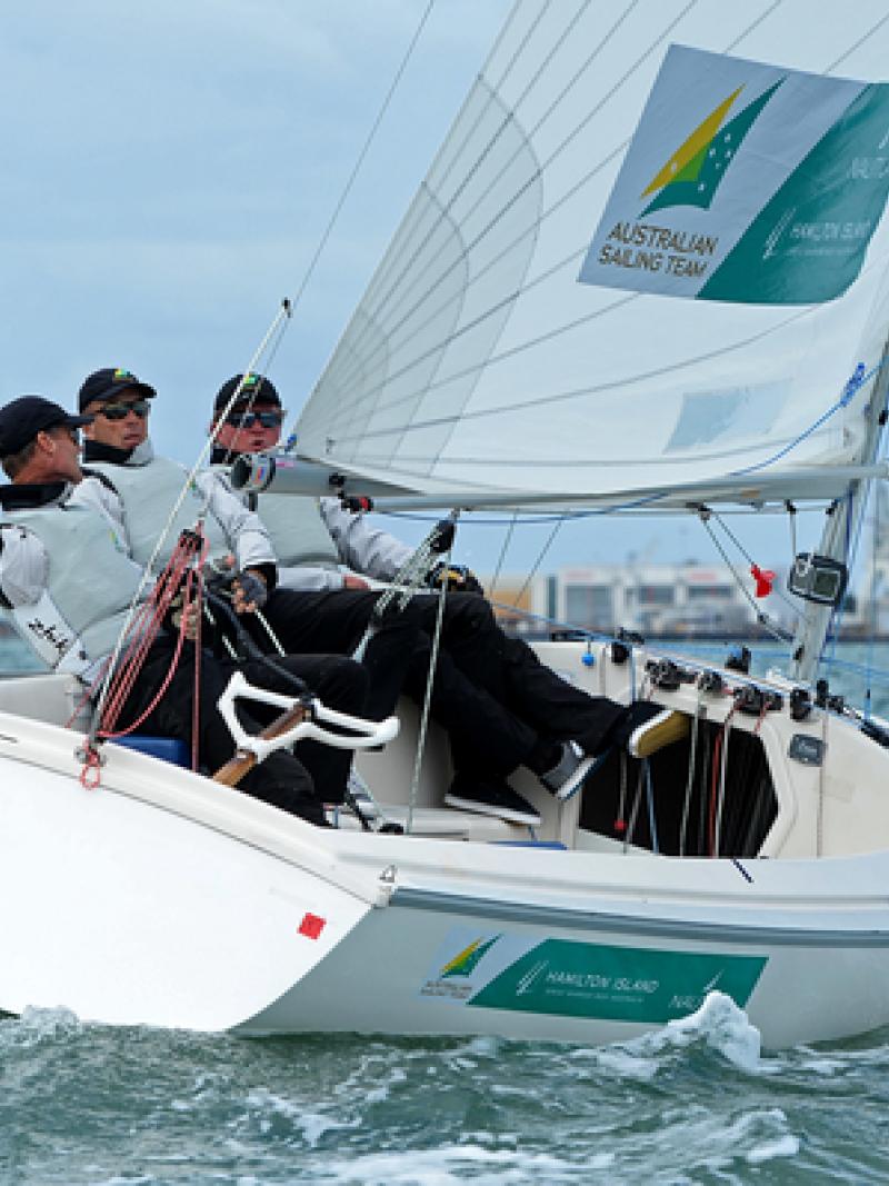 Three men in a boat sailing