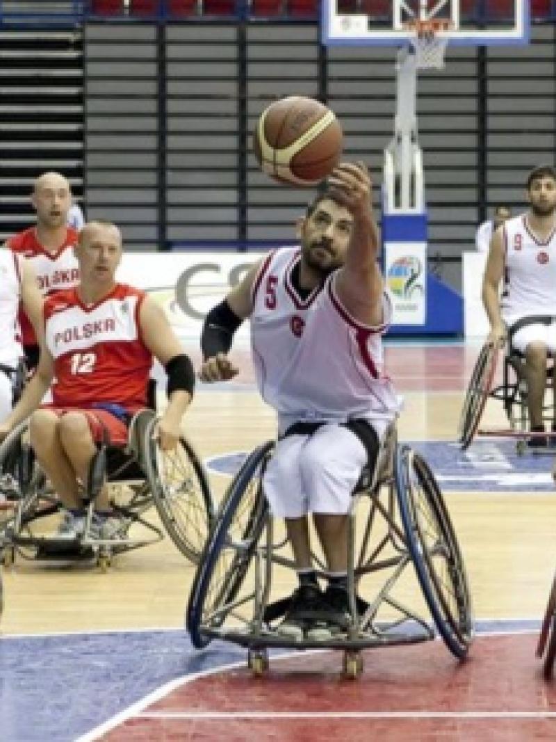 Man in wheelchair with basketball