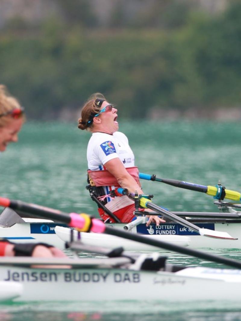 Woman in rowing boat celebrating