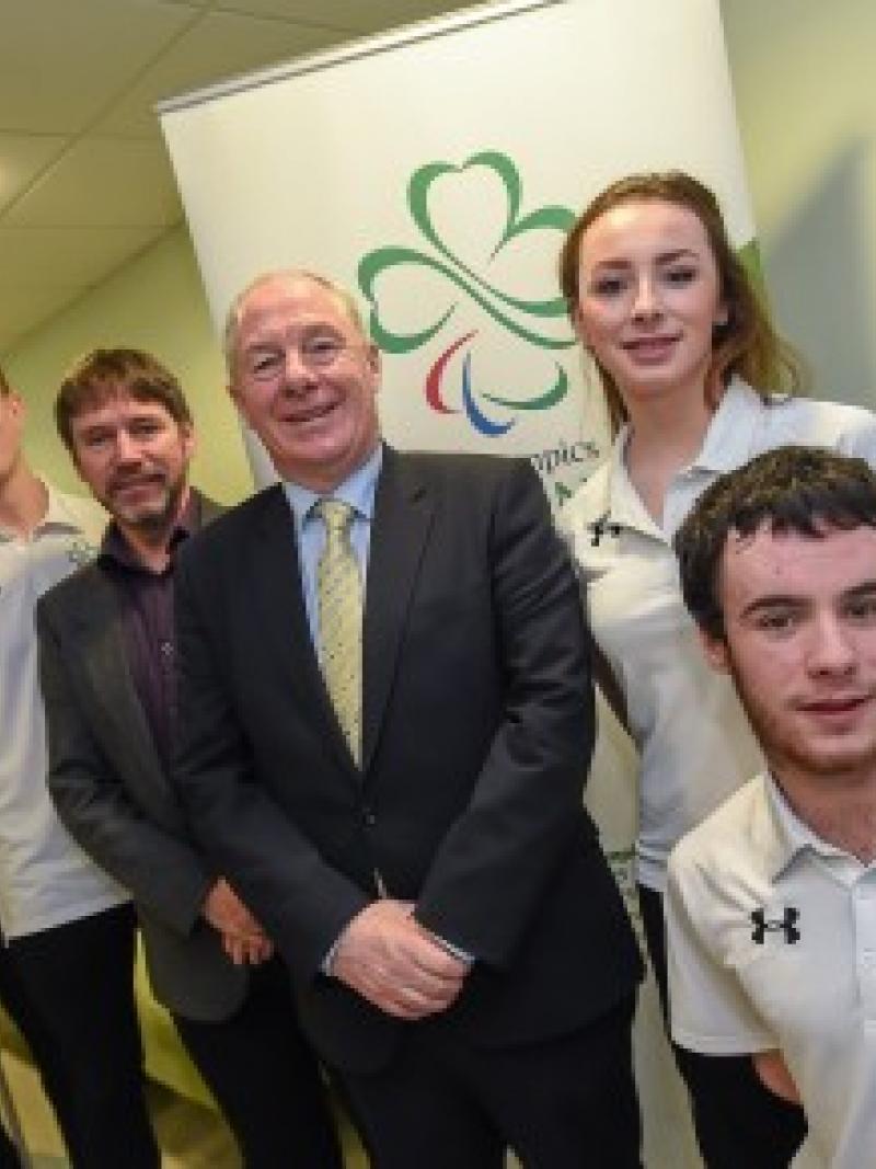 Six people pose in front of Paralympics Ireland banner
