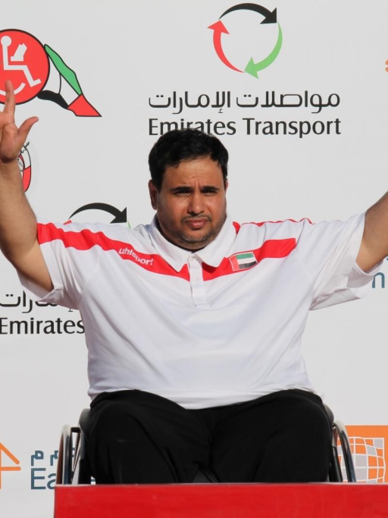 Man in wheelchair on a podium, celebrating