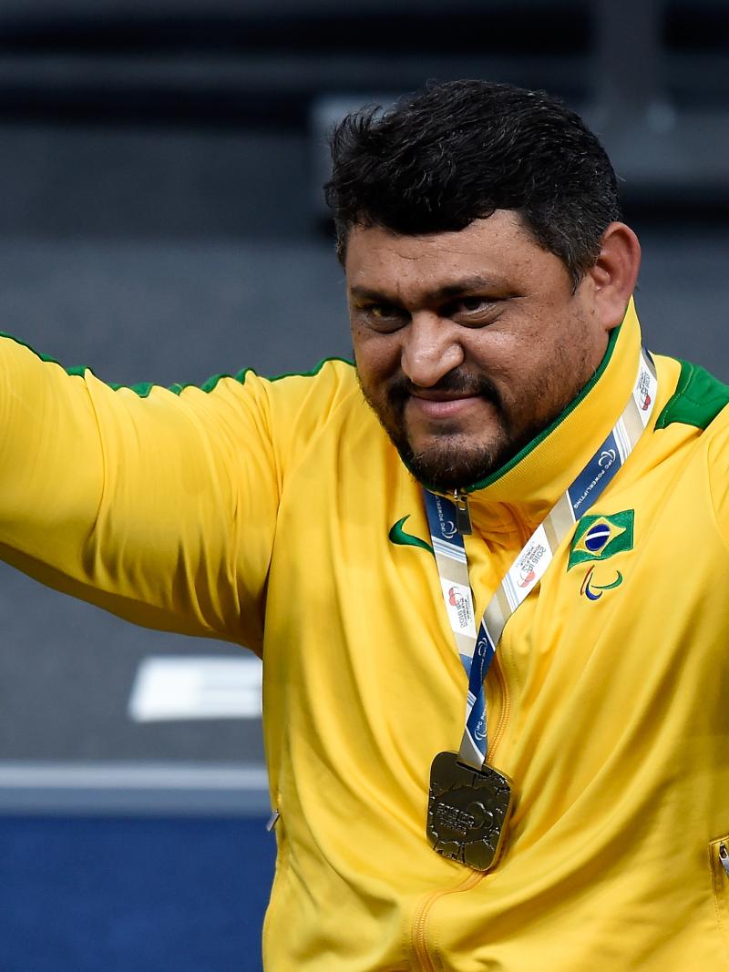 Man in yellow training suit raising his arms