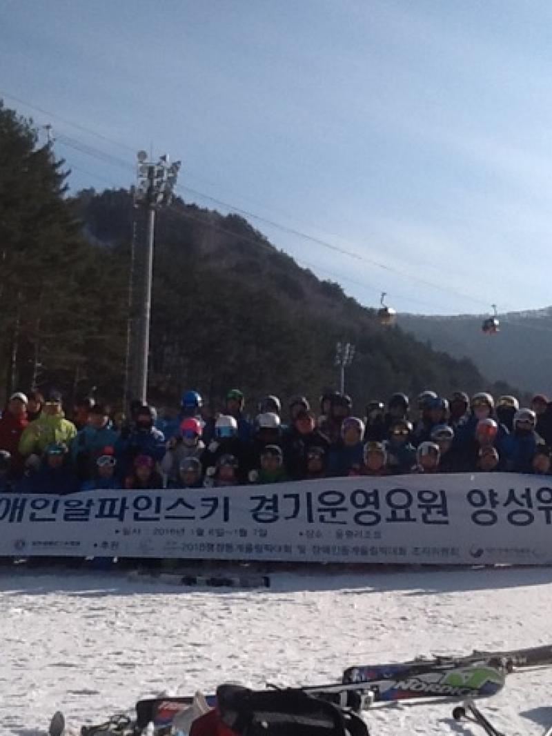 Group shot of people in the snow holding a banner