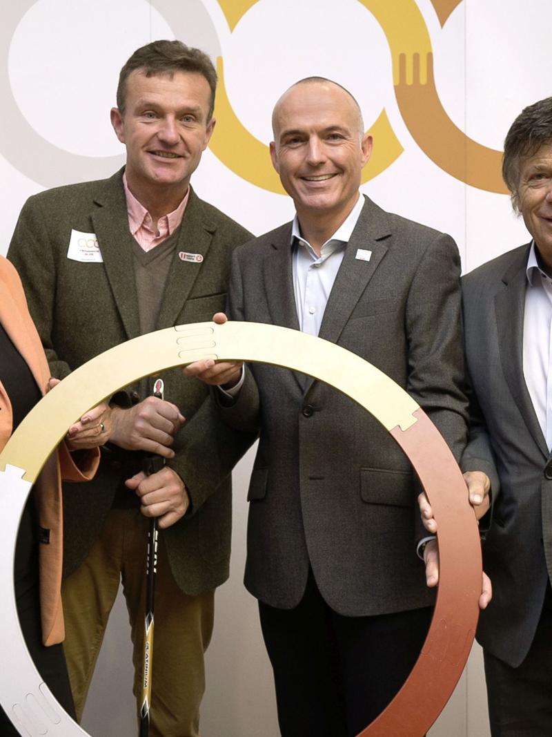 Group picture with four people smiling to the camera