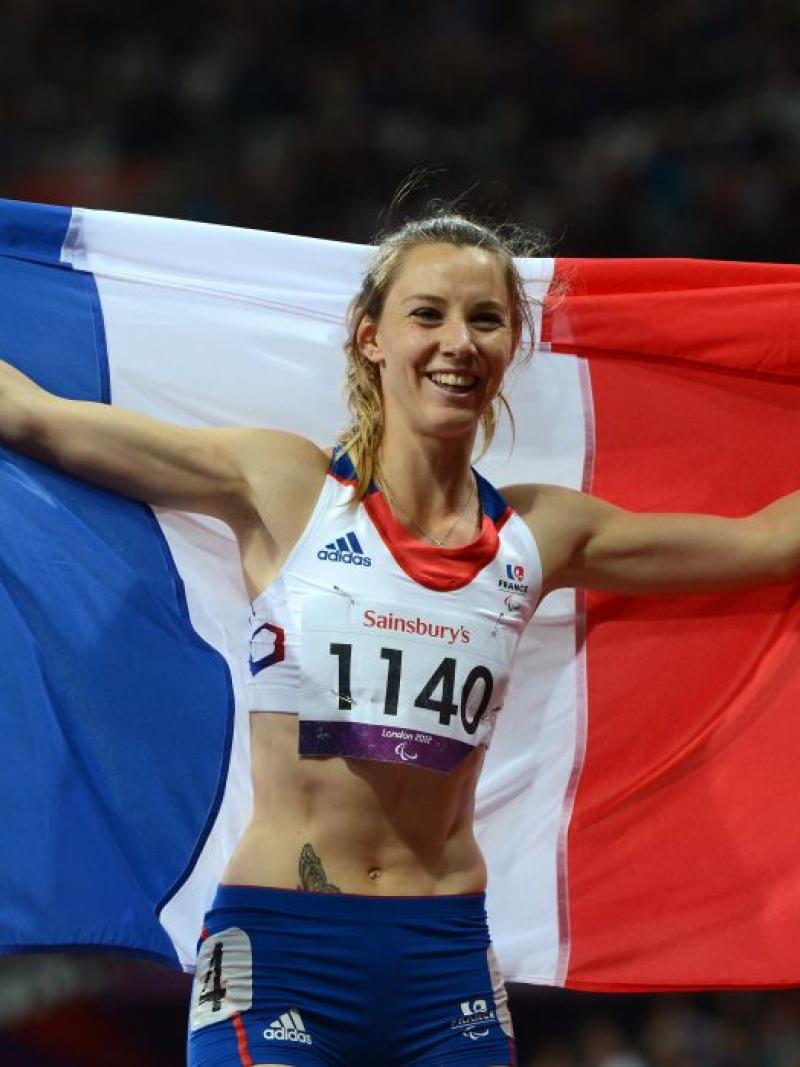 A picture of a woman holding a French flag