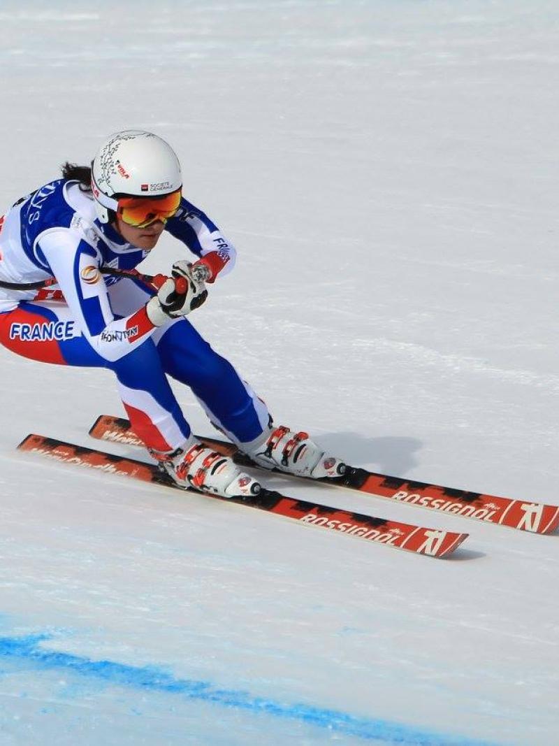 Female skier skiing downhill