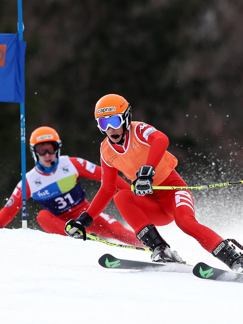 Skier and his guide on a slope