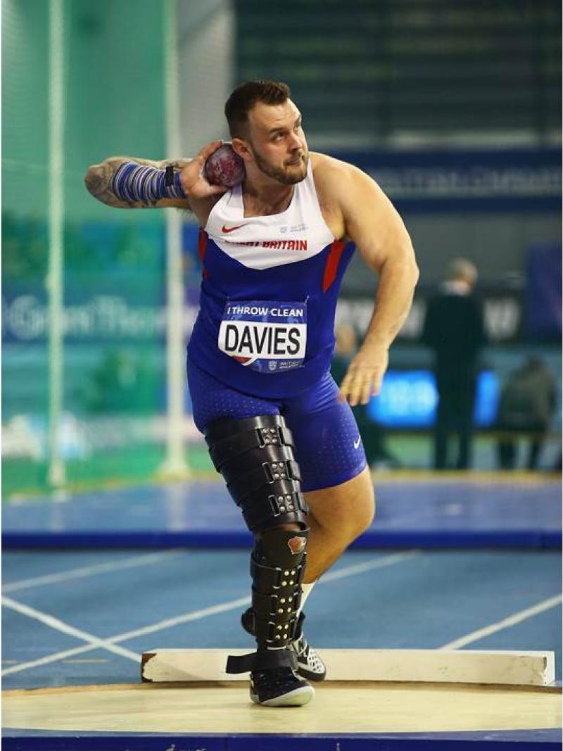 Man with prosthetic leg doing shot put