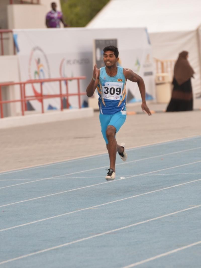 Man running on a blue track