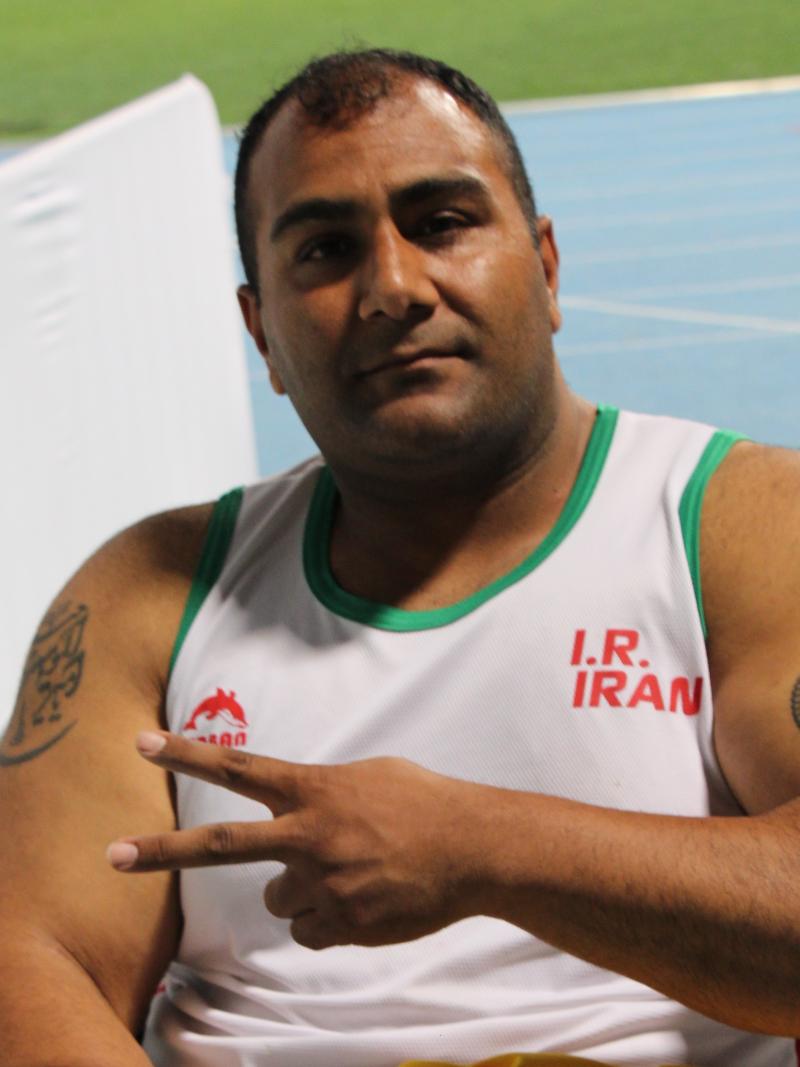 Iran's Hamed Amiri shows the "V" for victory sign with his fingers