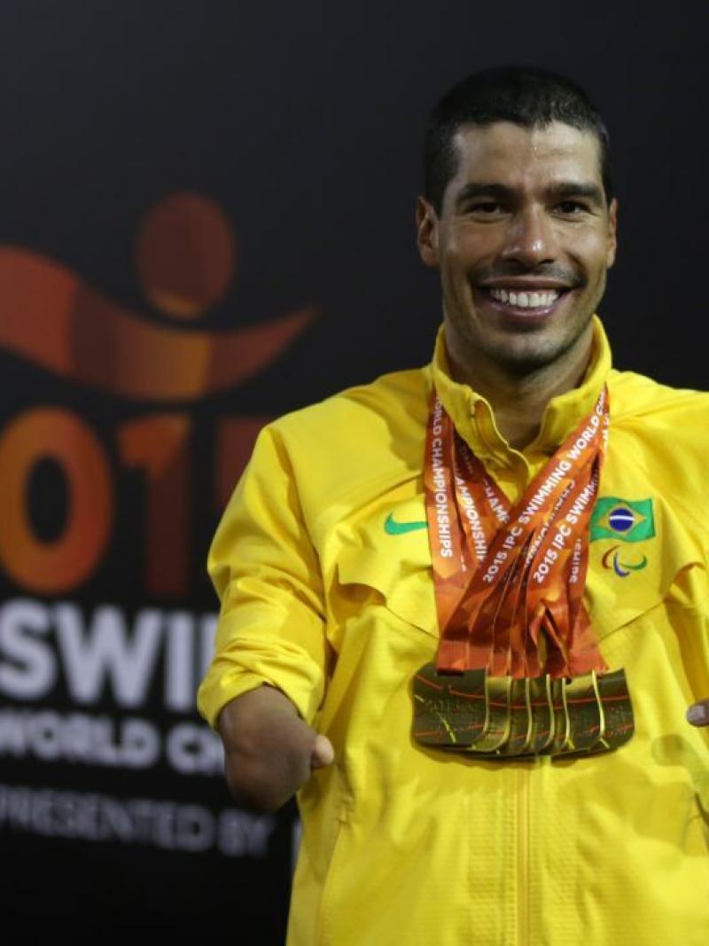 Daniel Dias of Brazil poses with his seven gold medal he won at the IPC Swimming World Championships in Glasgow, Great Britain.