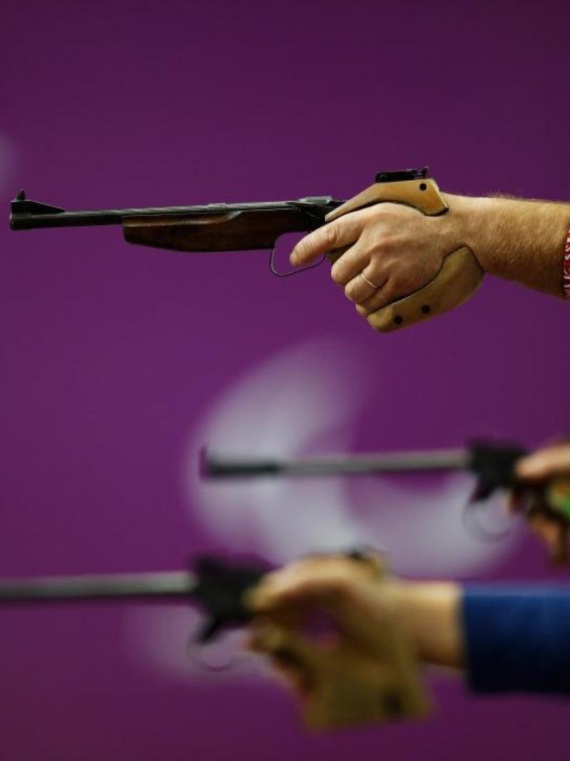 Competitors raise their pistols during the Mixed P4-50m Pistol-SH1 competition at the London 2012 Paralympic Games