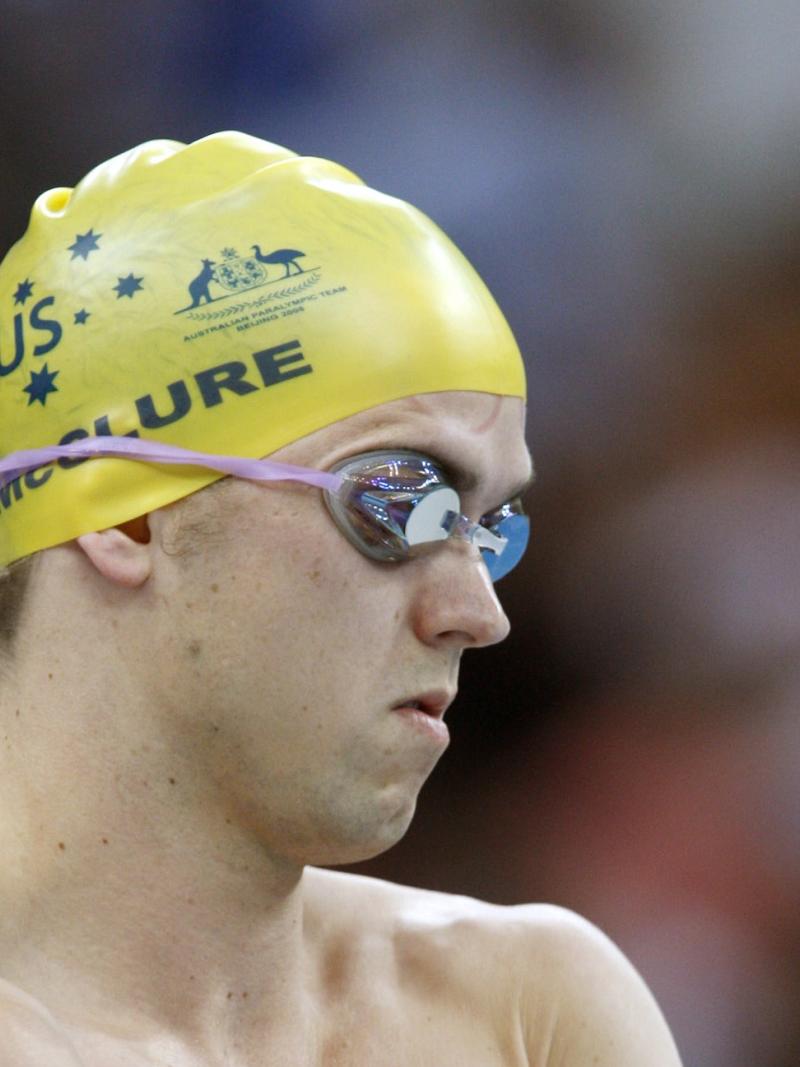 A visually impaired swimmer prepares for a race