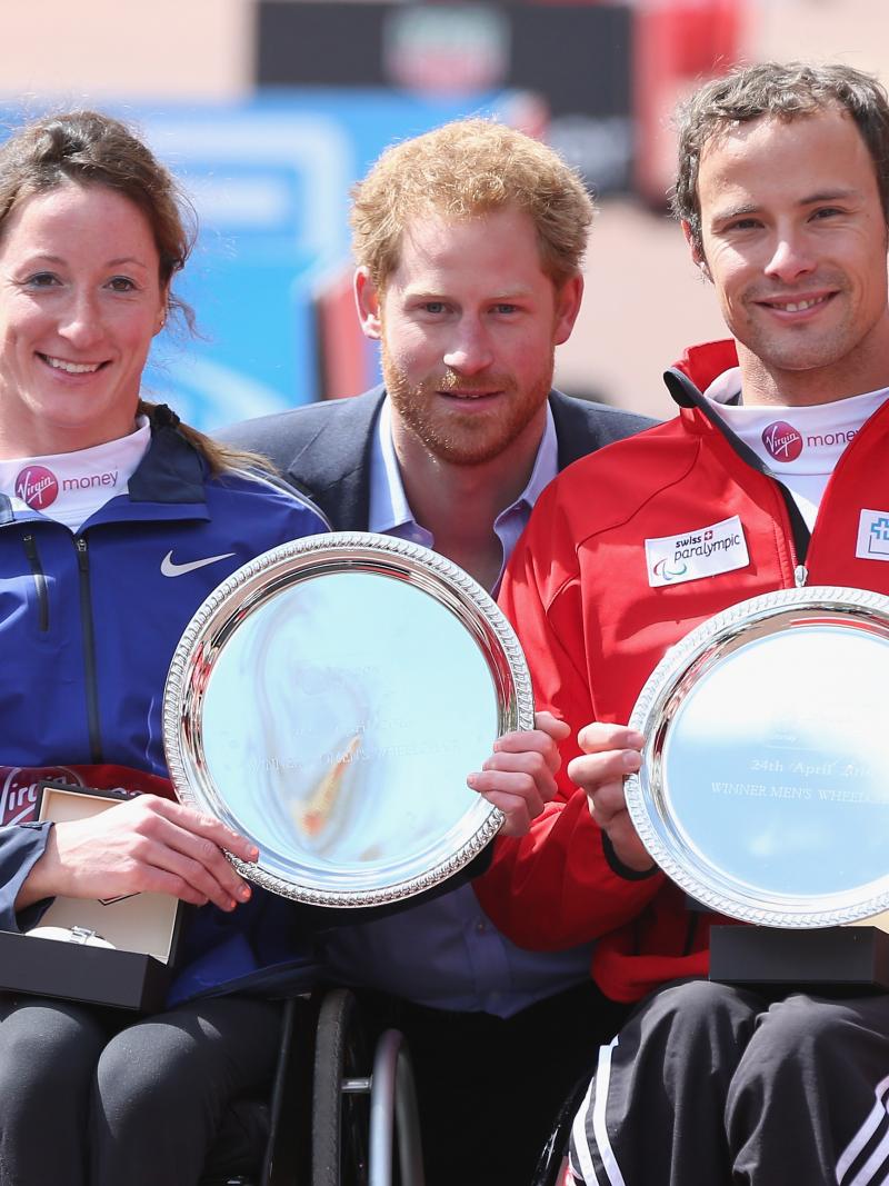Prince Harry poses with the USA's Tatanya Mcfadden and Switzerland's Marcel Hug after both won the 2016 Virgin Money London Marathon.