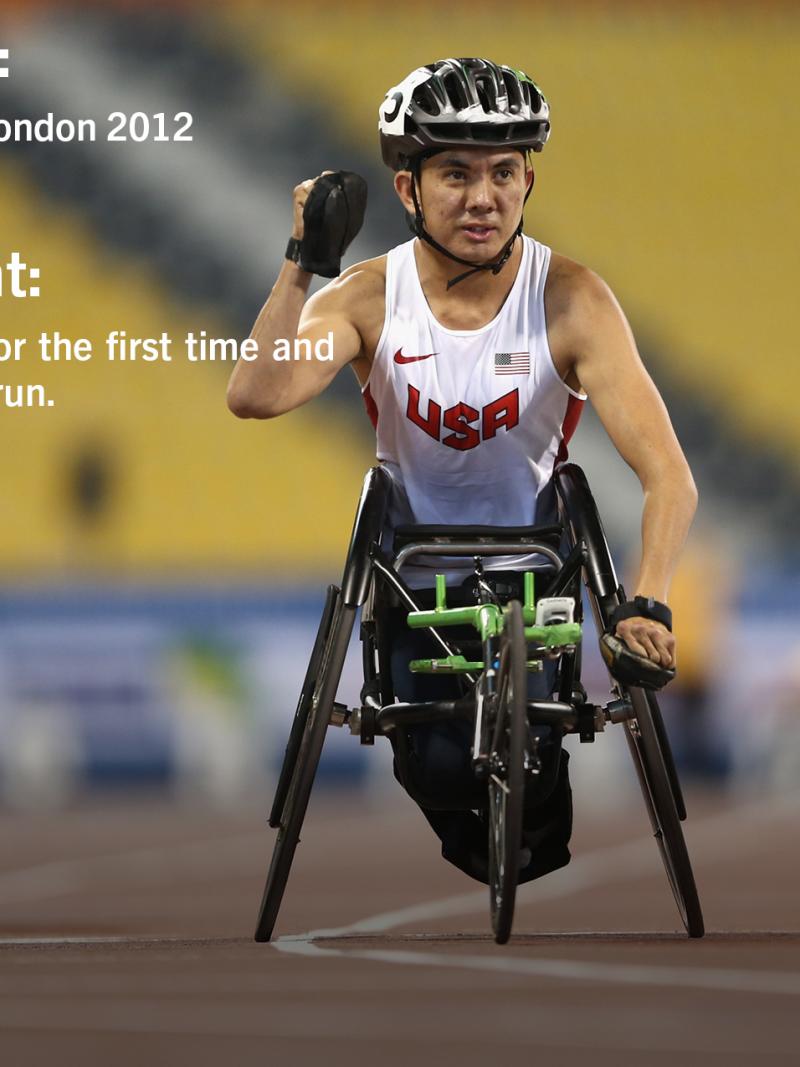 Wheelchar racer celebrates as he crosses a finish line.