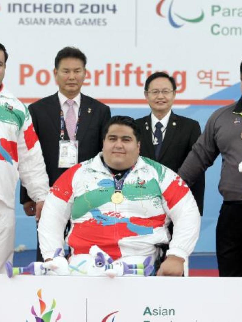 Three athletes on a podium received their medals.
