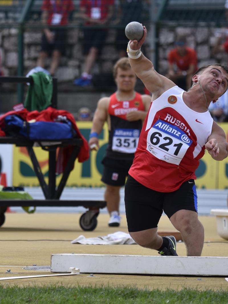 Short statued man doing shot put