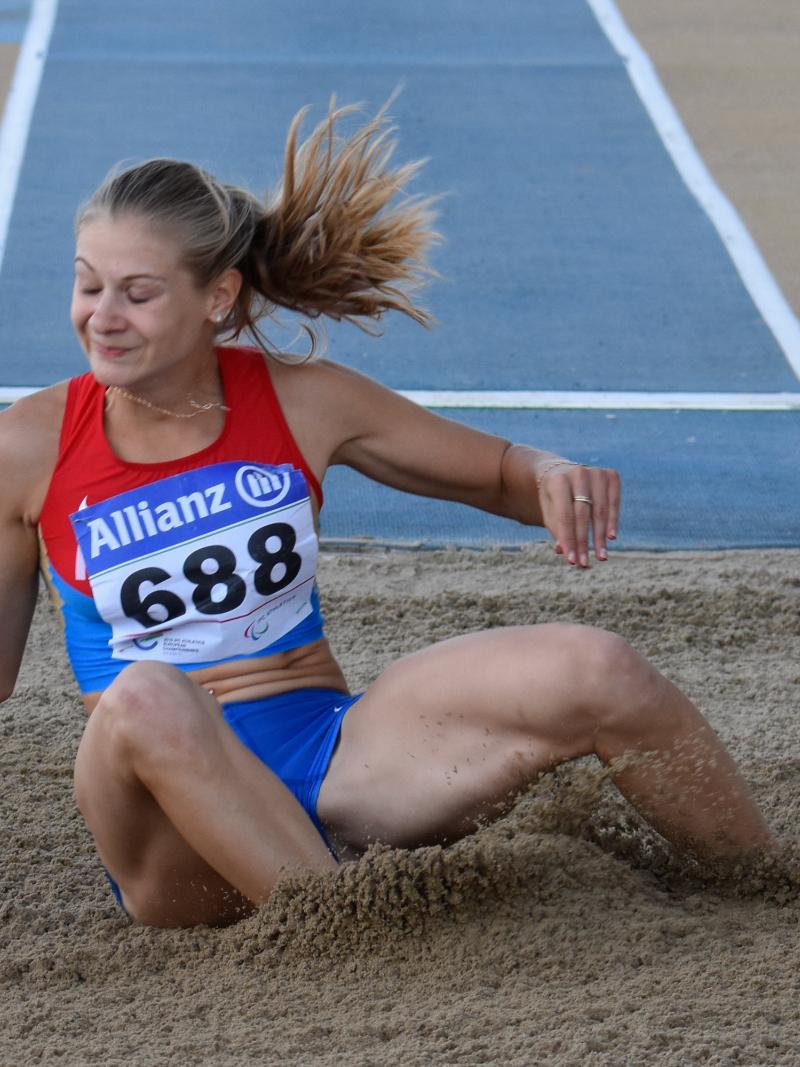 Woman lands in the sand pit