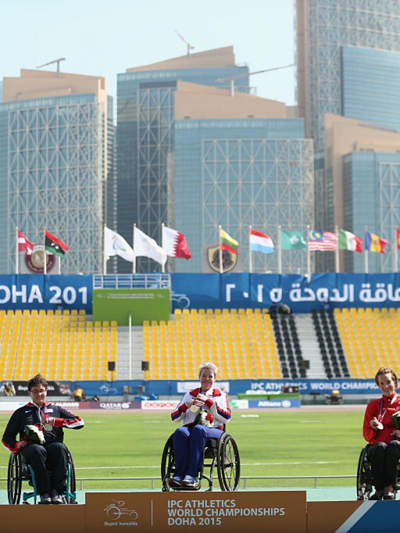 Podium with three women in wheelchairs