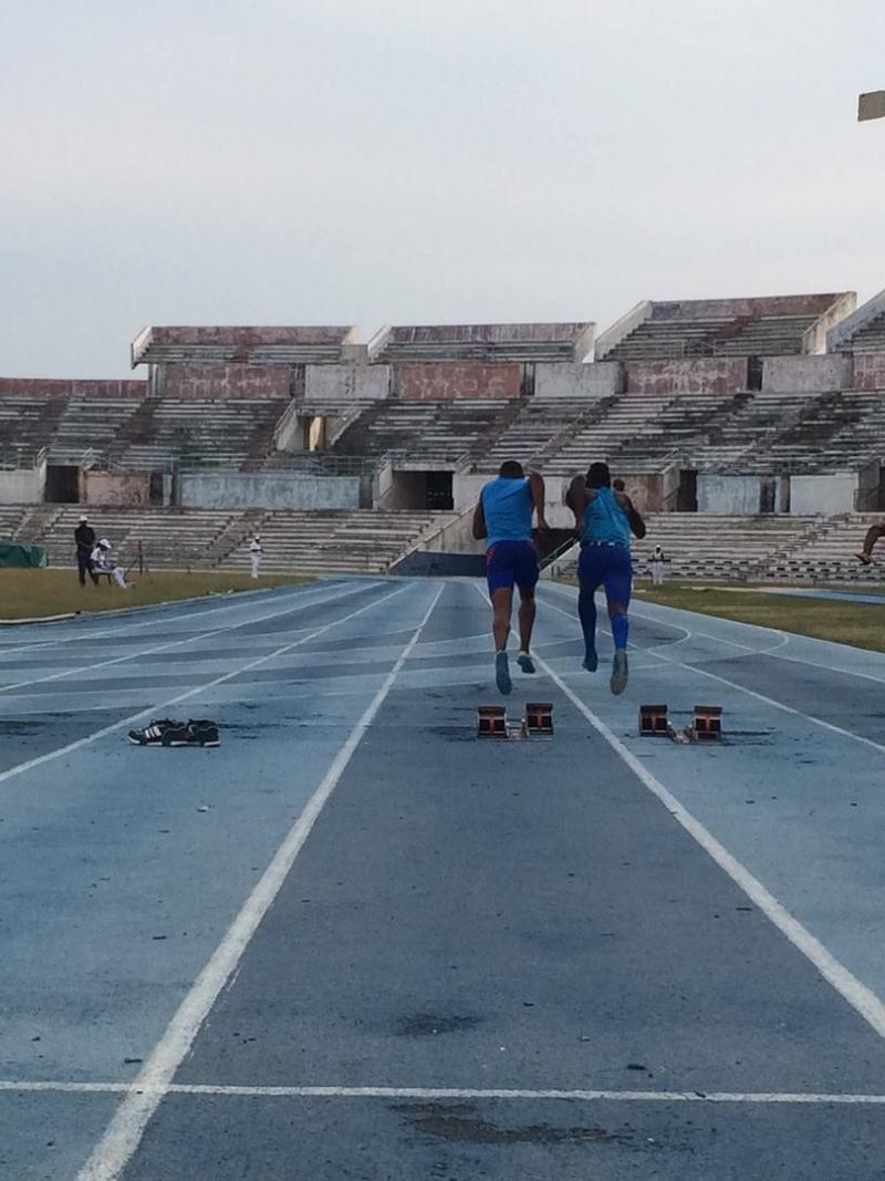 Track in an old stadium showing athletes and their guides starting