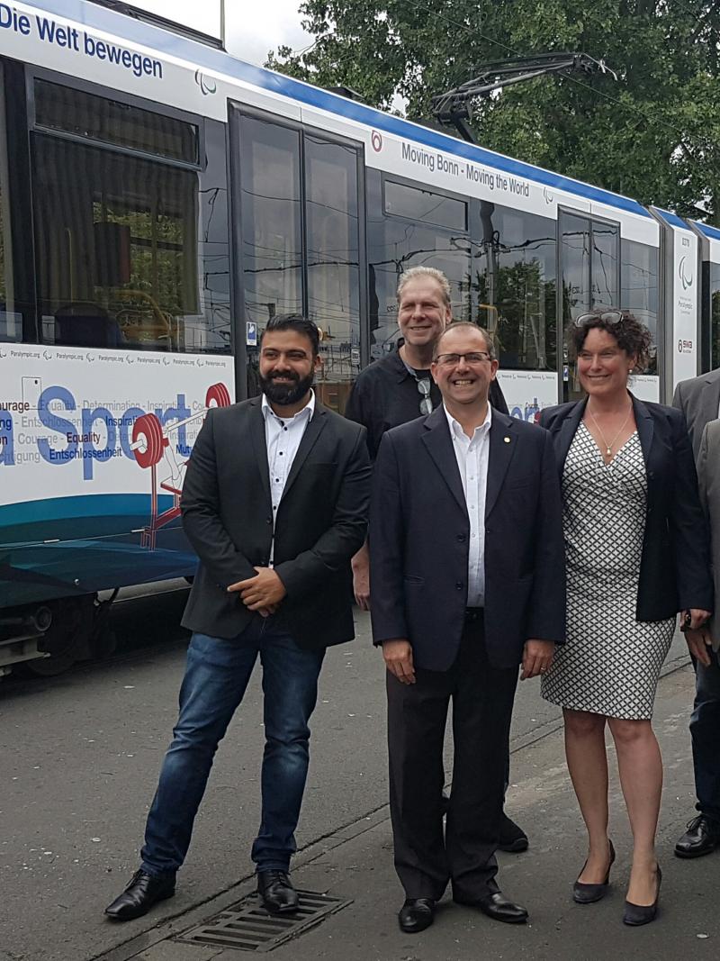 Five people standing in front of a tram in IPC design